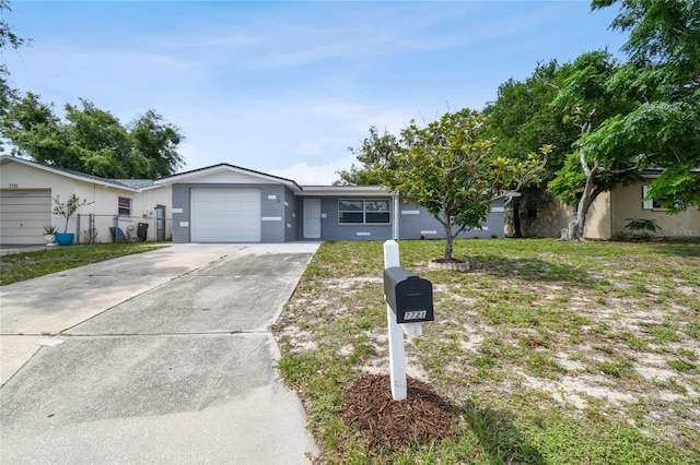 ranch-style home with a garage and a front lawn