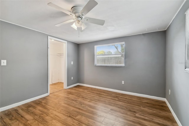 unfurnished room featuring ceiling fan and hardwood / wood-style flooring