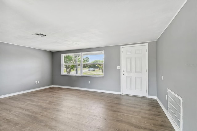 empty room with hardwood / wood-style flooring