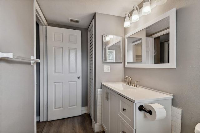 bathroom with vanity and wood-type flooring