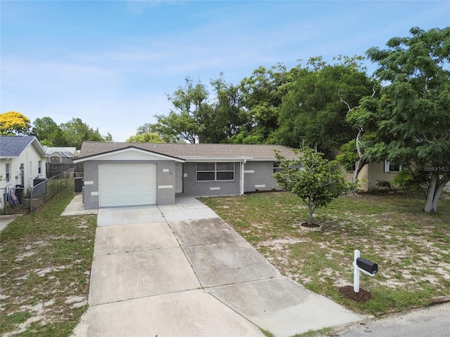 ranch-style house with a garage and a front lawn