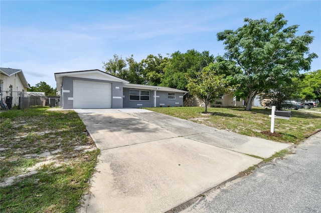 single story home featuring a garage and a front lawn