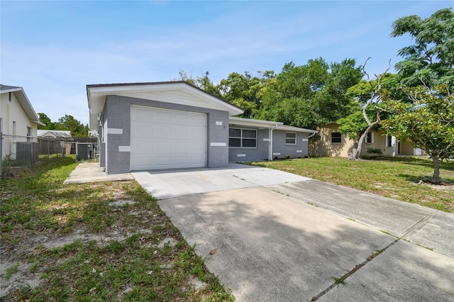 single story home with a garage and a front yard