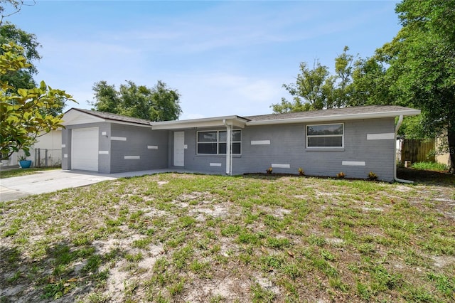 single story home featuring a garage and a front lawn