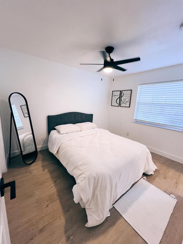 bedroom featuring ceiling fan and dark hardwood / wood-style flooring