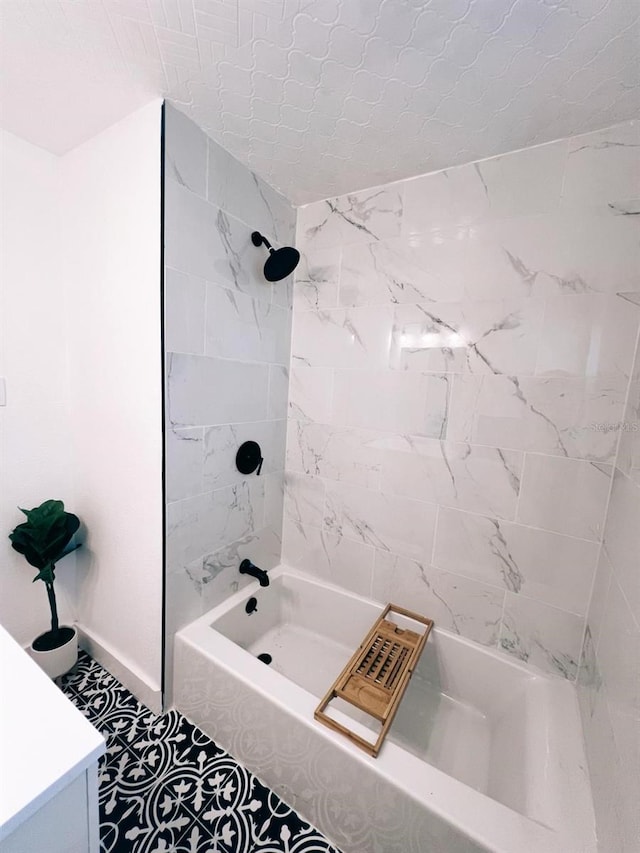 bathroom featuring tiled shower / bath and tile patterned floors