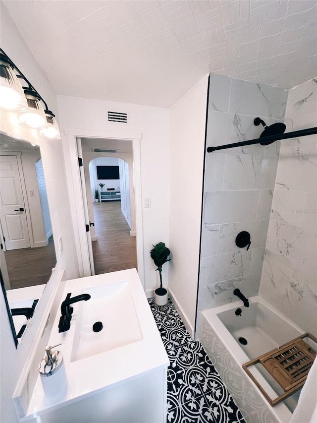 bathroom with vanity, tile patterned flooring, and tiled shower / bath combo