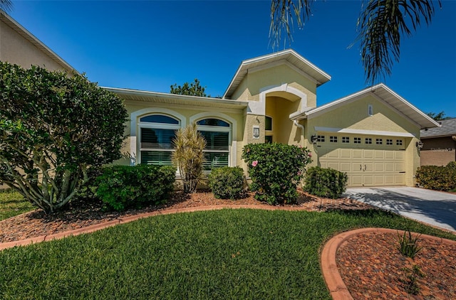 mediterranean / spanish-style house with a front yard and a garage