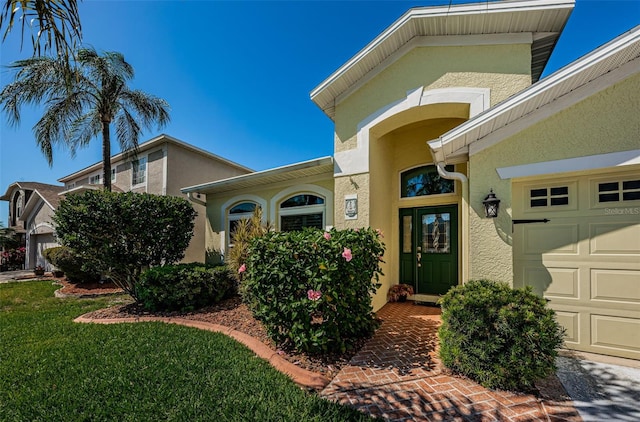 view of front of house featuring a garage and a front lawn