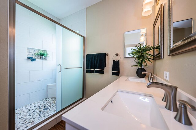 bathroom featuring hardwood / wood-style floors, vanity, and walk in shower