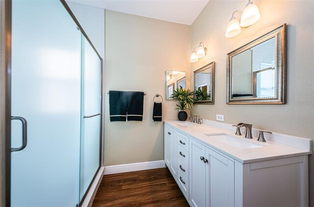 bathroom featuring wood-type flooring, vanity, and walk in shower