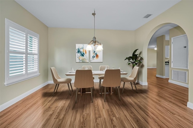 dining room with a chandelier and hardwood / wood-style flooring