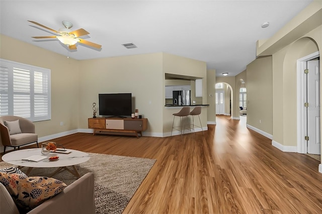 living room with ceiling fan and wood-type flooring