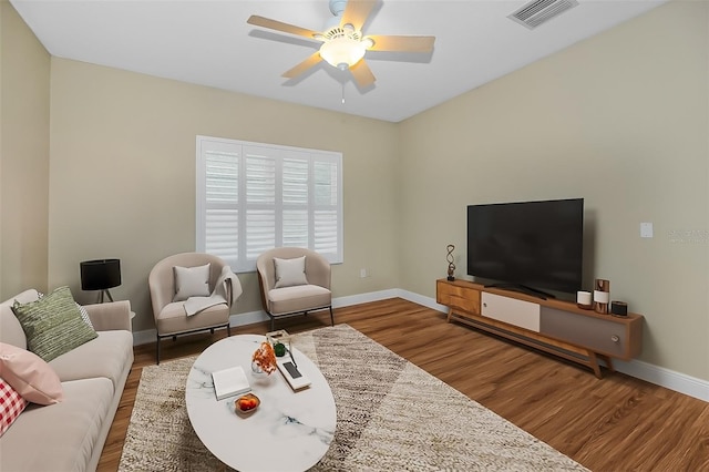 living room with ceiling fan and wood-type flooring