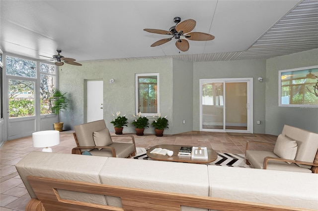 living room featuring light tile patterned floors and ceiling fan