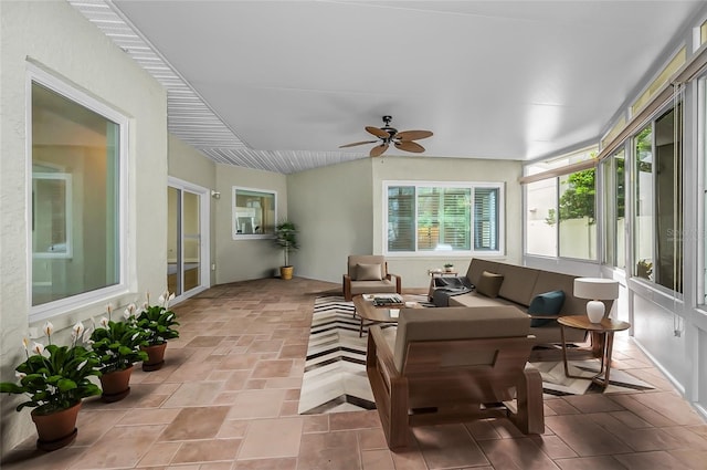 sunroom featuring ceiling fan