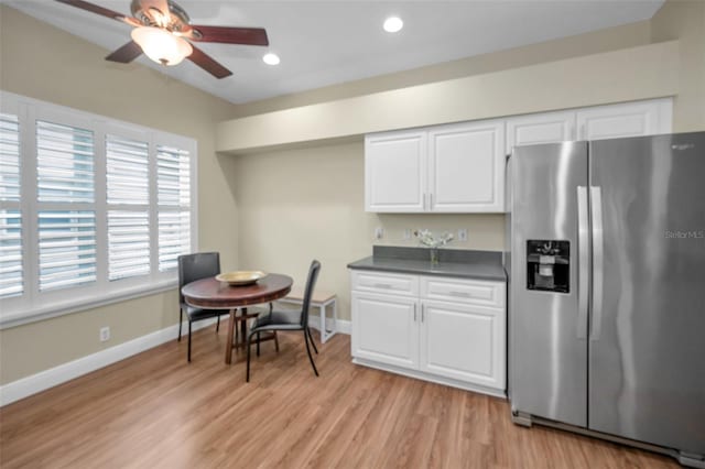 kitchen featuring white cabinetry, light hardwood / wood-style flooring, ceiling fan, and stainless steel refrigerator with ice dispenser