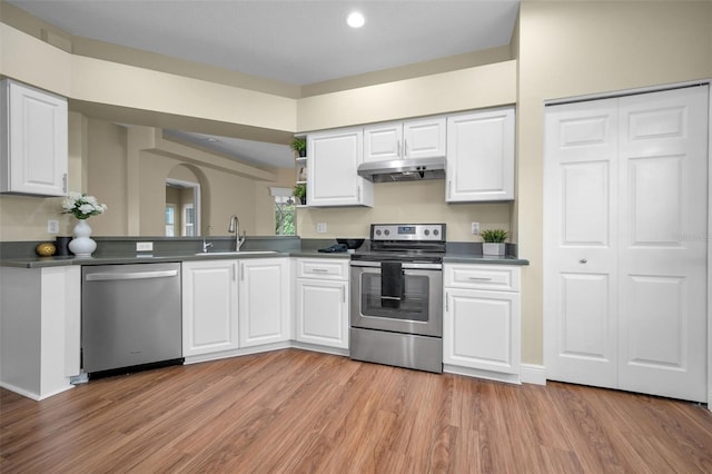 kitchen featuring light wood-type flooring, stainless steel appliances, white cabinetry, and sink