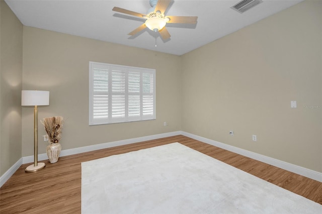 unfurnished room with hardwood / wood-style flooring and ceiling fan