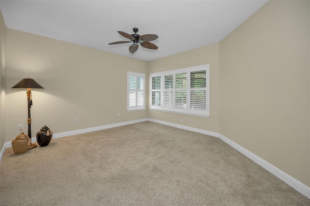 carpeted spare room featuring ceiling fan