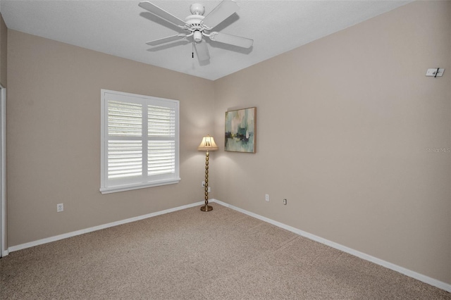 spare room featuring ceiling fan and carpet floors