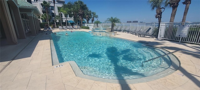 view of swimming pool with a patio and pool water feature