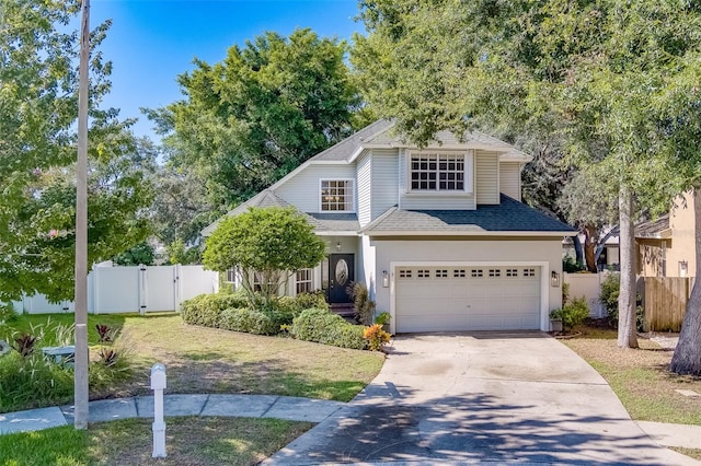 view of front of home with a garage and a front lawn