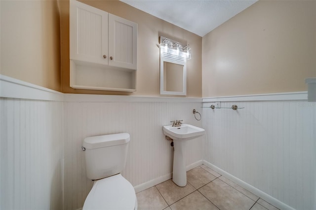 bathroom with tile patterned flooring and toilet