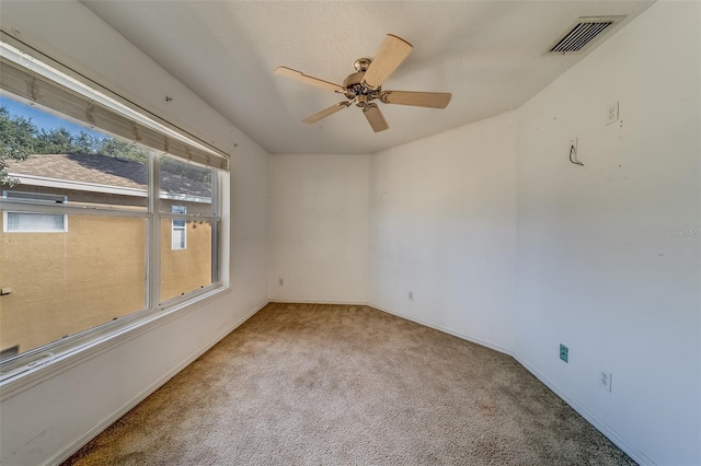 empty room featuring light carpet and ceiling fan