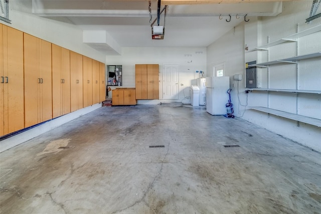 garage with electric panel, white fridge, a garage door opener, and washing machine and clothes dryer