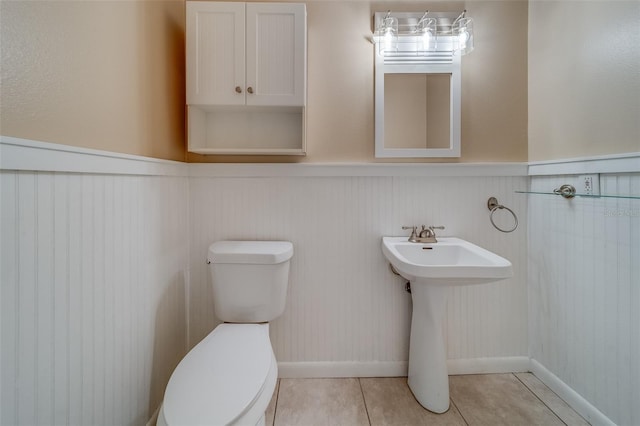 bathroom featuring tile patterned flooring and toilet