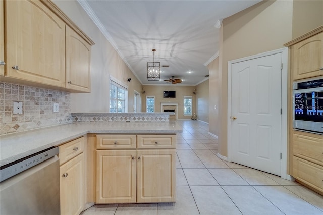 kitchen featuring kitchen peninsula, light brown cabinetry, stainless steel appliances, light tile patterned floors, and decorative light fixtures