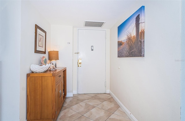 doorway with light tile patterned floors