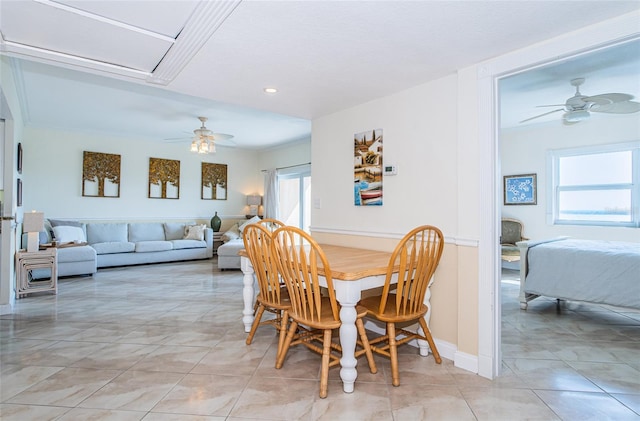 tiled dining area with ceiling fan