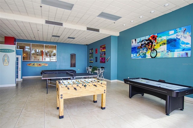 recreation room with a drop ceiling and tile patterned floors