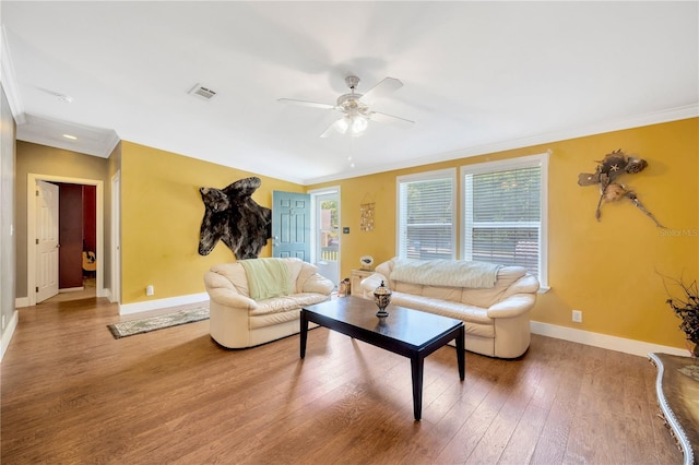 living room with ceiling fan, wood-type flooring, and ornamental molding