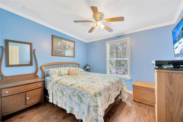 bedroom featuring ceiling fan, ornamental molding, and dark wood-type flooring