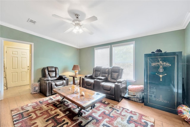 living room featuring light hardwood / wood-style floors, ceiling fan, and crown molding