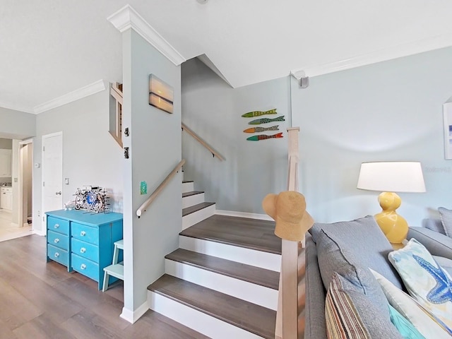 stairs featuring crown molding and hardwood / wood-style flooring