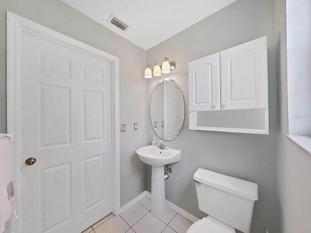 bathroom with tile patterned flooring, toilet, and sink