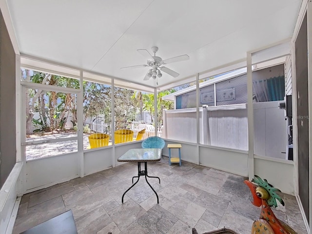 sunroom featuring ceiling fan and a healthy amount of sunlight