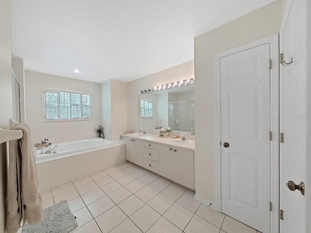 bathroom with shower with separate bathtub, vanity, and tile patterned floors