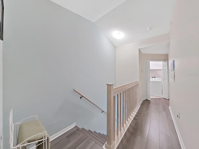 stairs with hardwood / wood-style floors and a textured ceiling