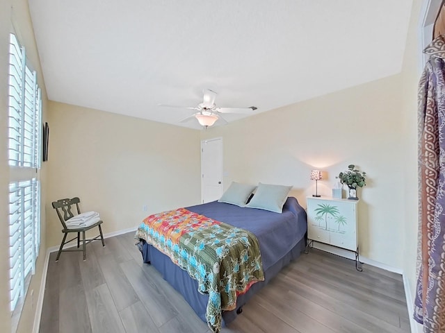 bedroom with hardwood / wood-style floors and ceiling fan