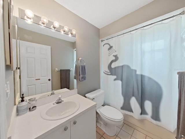 bathroom featuring tile patterned flooring, vanity, and toilet