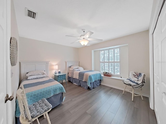 bedroom featuring ceiling fan, a closet, and wood-type flooring