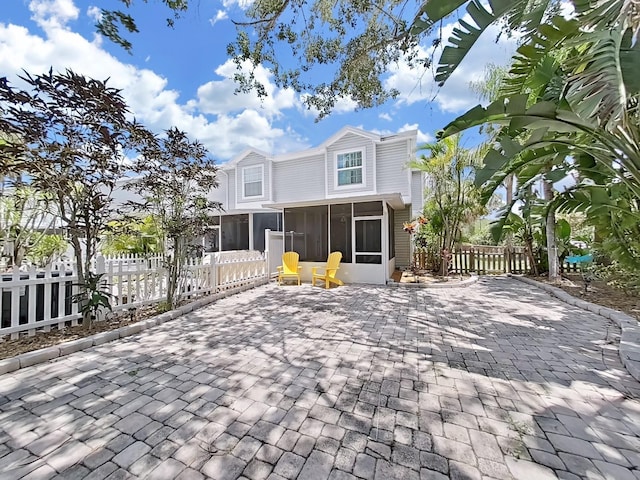 view of front of property with a sunroom and a patio area