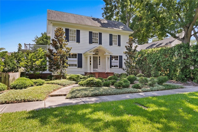 colonial inspired home with a front yard