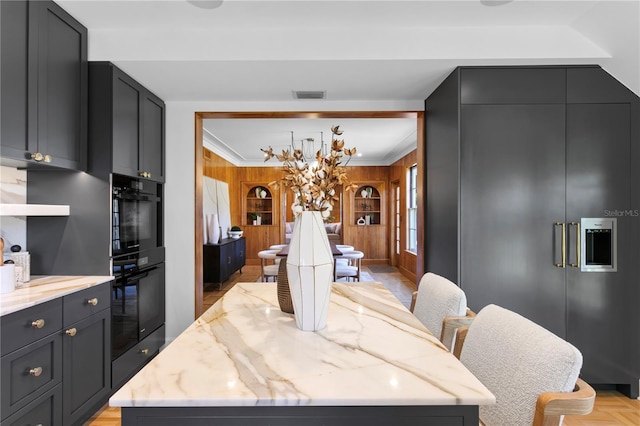 dining room with built in shelves and crown molding