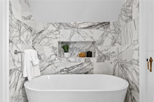 bathroom featuring a bathing tub and tile walls